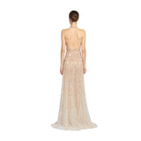 Rear view studio shot of a model showing the open back, criss-cross strap detailing, and floor-sweeping pooling hem of the Zuhair Murad champagne gold embellished tulle gown, available at the BLUE SALON .