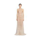 Front studio portrait of a model showcasing the sheer champagne gold Zuhair Murad halter neck evening gown with geometric crystal and sequin embellishments, from the BLUE SALON.
