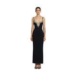 Front studio portrait of a model wearing the sleek black Zuhair Murad crepe column gown featuring an intricate crystal and pearl bib neckline, from the BLUE SALON shop.