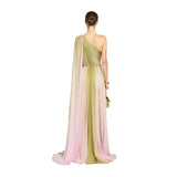 Rear view studio shot of a model highlighting the sleek hair bun, asymmetric open back, and sweeping floor-length hemline of the Zuhair Murad ombré pleated silk gown.