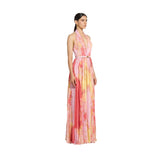 Three-quarter studio shot of a model showcasing the fluid movement, watercolor floral pattern, and accordion pleats of the pink multi Zuhair Murad halter evening gown.