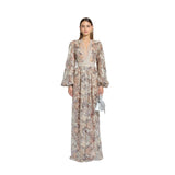 Front studio portrait of a model wearing the shimmering Zuhair Murad rose gold sequin-embellished floral tulle gown with long bishop sleeves, from the BLUE SALON shop.