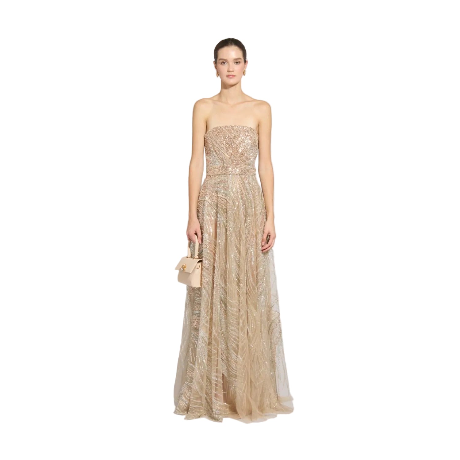 Front studio portrait of a model showcasing the floor-length, shimmering champagne gold Zuhair Murad strapless tulle evening gown while carrying a small beige top-handle bag, available at the BLUE SALON.