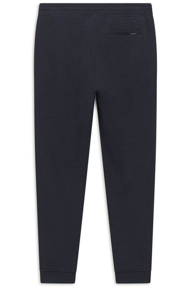 Navy blue jogger trousers with an elasticated waistband, a small back welt pocket with a Bugatti label, and ribbed ankle cuff