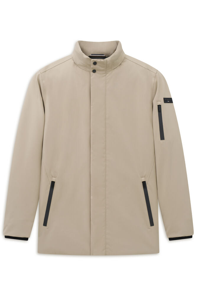 Beige jacket with stand collar, snap buttons, black-trimmed side pockets, a left sleeve pocket with logo, and black cuffs.