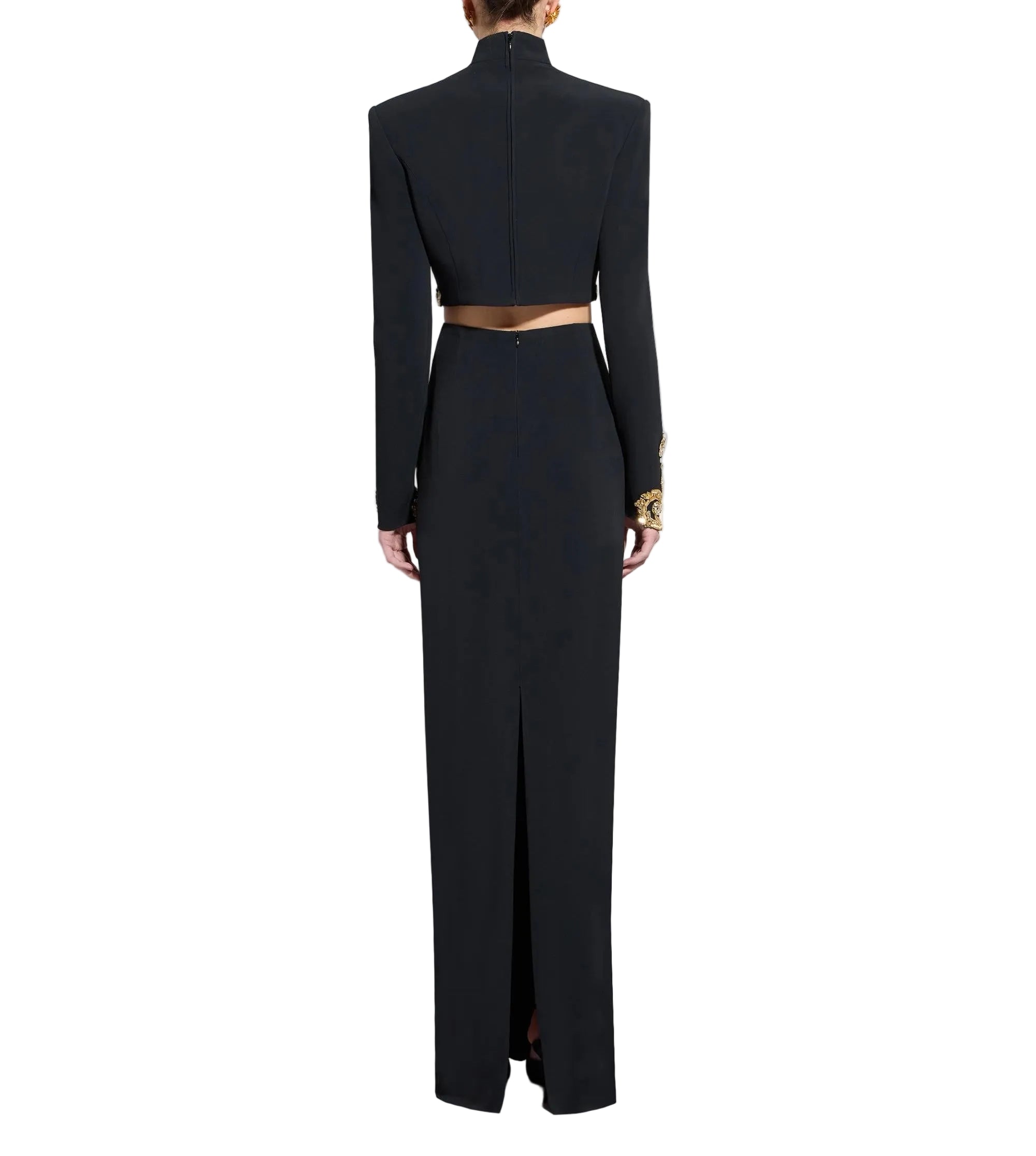 Black cropped top with high neck, structured shoulders, long sleeves with gold-toned crystal cuffs, and a matching long skirt