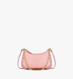 Close-up of the front pouch’s embossed MCM logo and the high-shine gold-plated chain link strap.