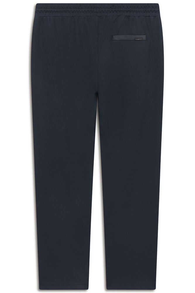Navy blue trousers with an elasticated waistband and a small black label patch on the upper back.