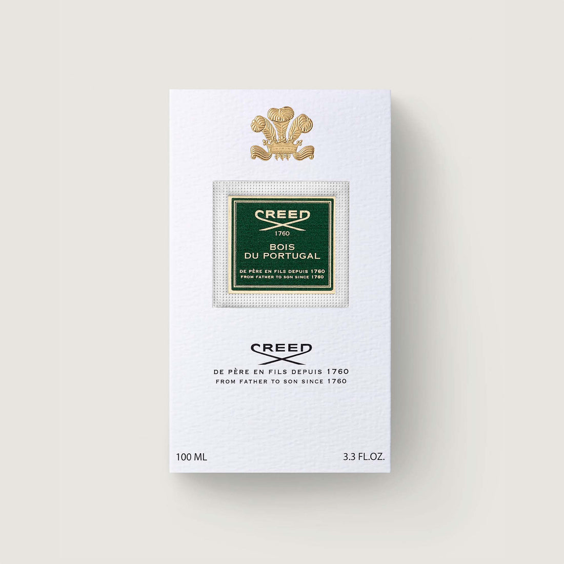 White rectangular perfume box with a gold-toned crest, a green label with "CREED Bois Du Portugal" text, and "100 ML".