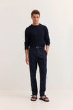 Navy blue casual trousers with a flat front, belt loops, and side pockets. They have a straight leg fit.