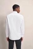 White long-sleeve casual shirt with a classic collar, buttoned cuffs, and a curved hem. Smooth fabric.