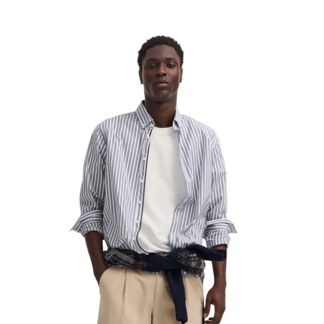 Men's long-sleeved button-down shirt with white, navy blue, and light blue vertical stripes, sleeves rolled up.