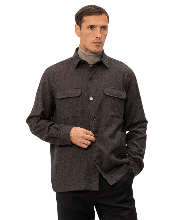 Brown men's sport jacket with a pointed collar, button-front closure, long sleeves, and two buttoned chest flap pockets.