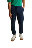 Navy blue jogging pants with an elasticated drawstring waistband, side pockets, and ribbed ankle cuffs.