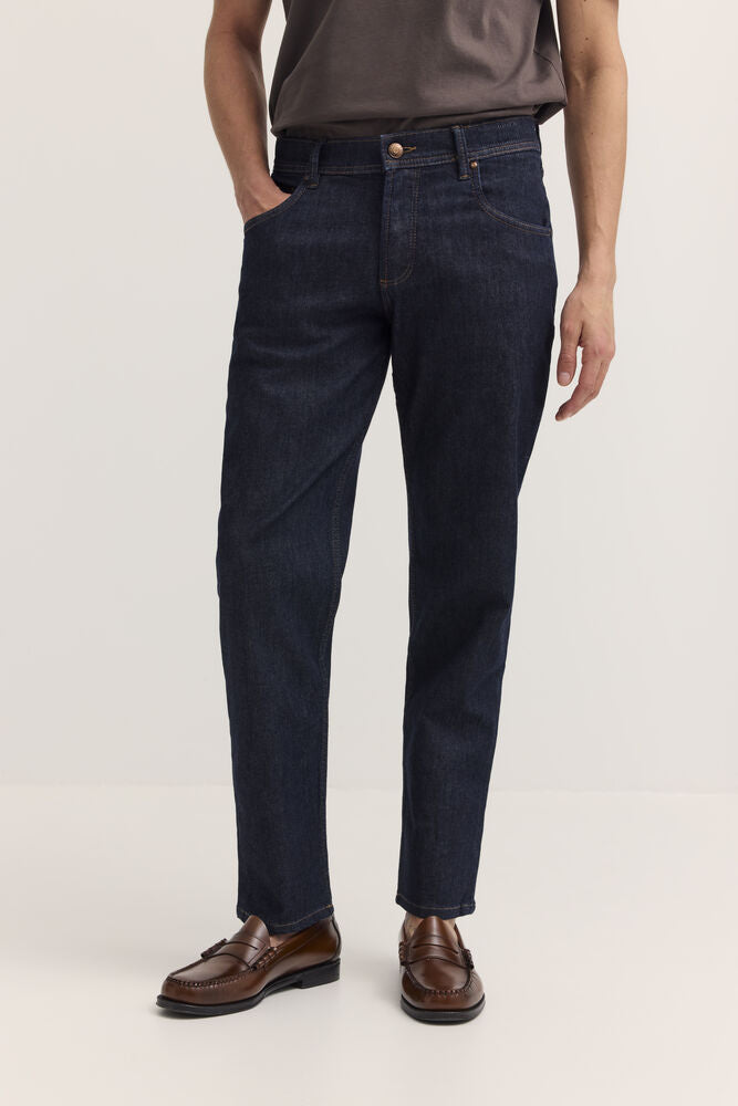Dark navy blue denim jeans with a straight leg, five-pocket style, gold-toned button closure, and belt loops.