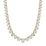 Gold-toned graduated necklace with numerous round clear stones, each in a four-prong setting, increasing in size towards the