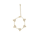 David Charles girls gold-tone bracelet with five white butterfly charms featuring iridescent inlays and beaded gold borders.