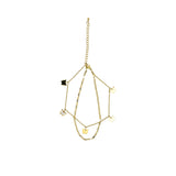 David Charles girls' layered gold-tone bracelet featuring multiple butterfly charms in black, white, and gold on a white background.