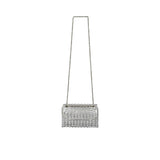 A front-facing view of a luxury David Charles silver evening bag, heavily embellished with square crystals and a long silver chain strap on a white background.