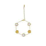 David Charles girls gold-tone bracelet with alternating white pearlescent flowers and textured gold flowers on a white background.