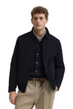 Dark blue blouson jacket with a stand-up collar, full-zip front, zippered side pockets, and a small emblem on the left sleeve