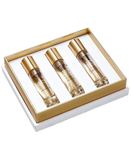 White gift box with gold-toned trim, containing three labeled clear glass fragrance bottles with gold-toned caps.