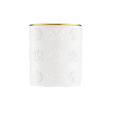 White cylindrical candle with a gold-toned rim and embossed patterns of horse heads, crests, and "CREED" text.