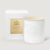 White cylindrical candle with embossed crests and horses, and a gold-toned lid embossed with 'CREED 1760'.