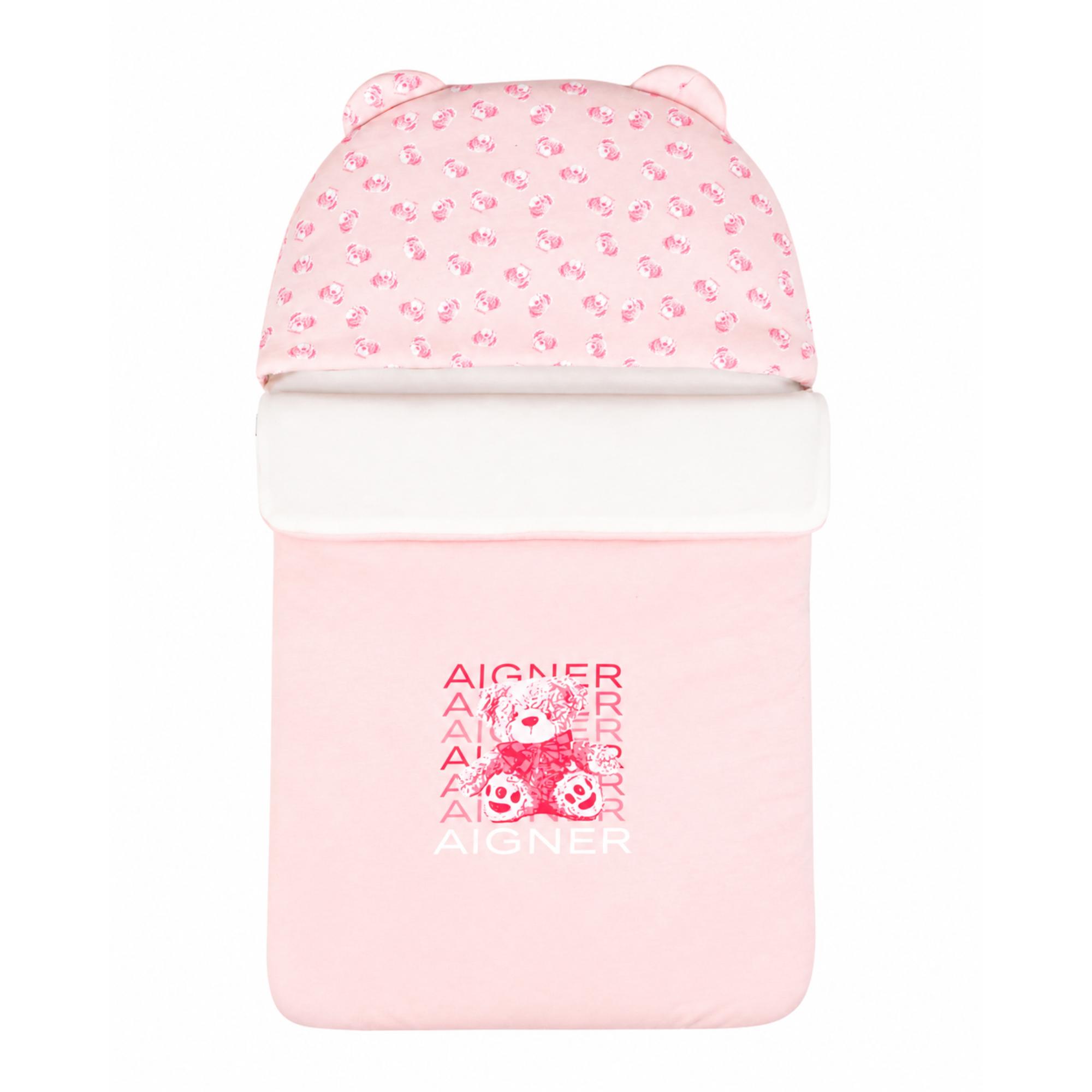 Pink baby nest with a patterned hood featuring bear ears, a white plush trim, and a large pink teddy bear graphic with "AIGNE