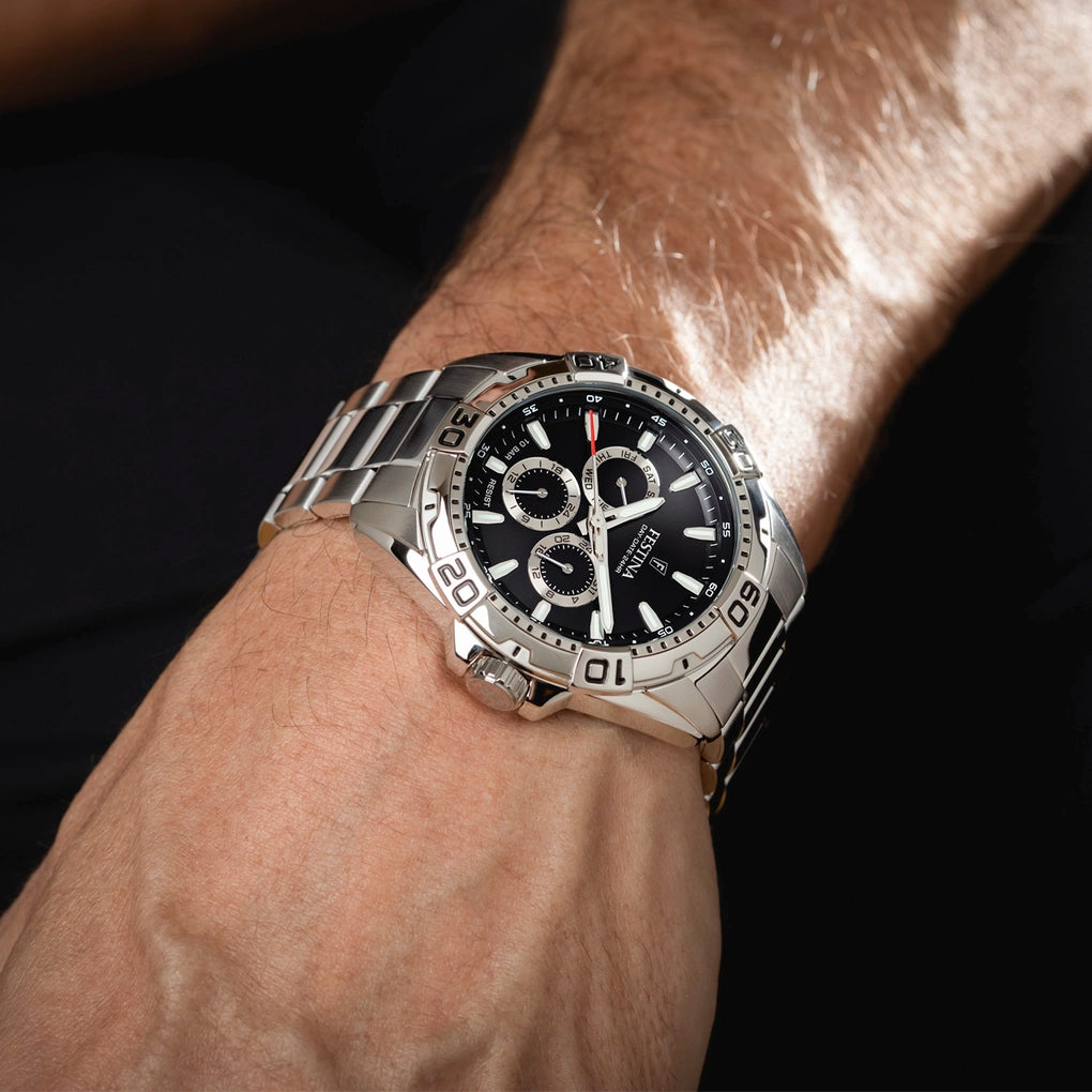 Festina men's stainless steel watch with a black dial, three sub-dials, white markers, and a link bracelet.