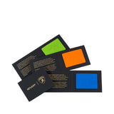 Three black folded cards with embossed Lamborghini bull logo patches: lime green, orange, and blue. Cards have text.