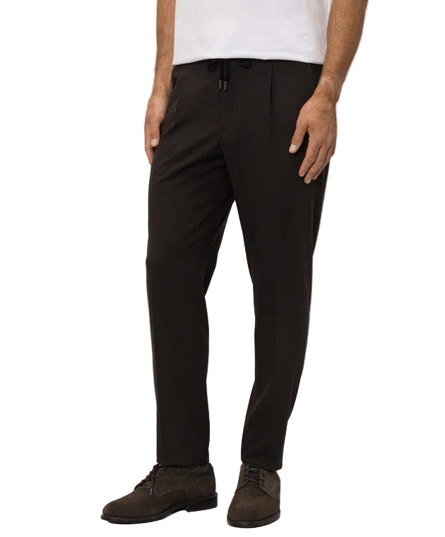 Deep brown men's relaxed fit trousers with a black drawstring waist and front pleats.