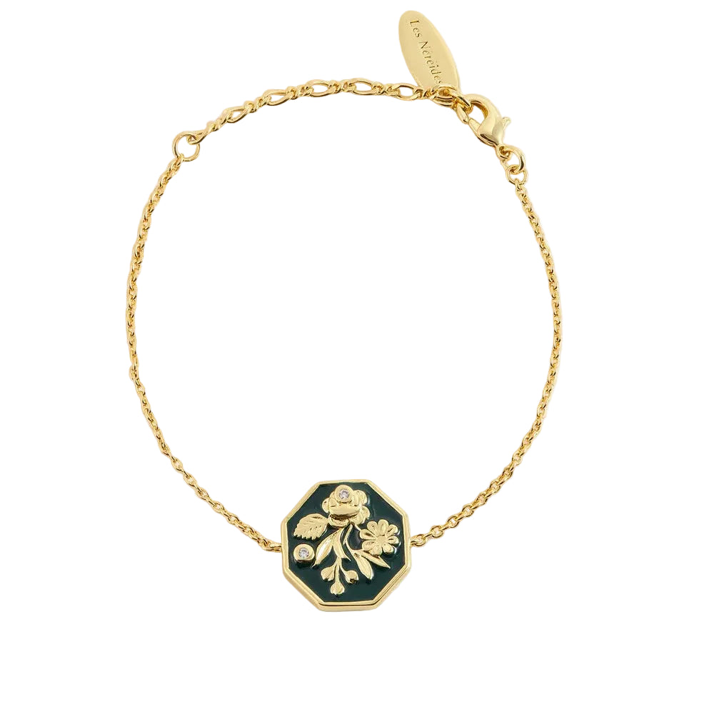 Gold-toned chain bracelet with a dark green octagonal charm featuring a gold-toned raised floral design and two clear stones.