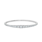 Silver-toned stretch cuff bracelet with a continuous line of clear, round, graduated cubic zirconia stones.