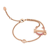 Rose gold-toned chain bracelet with a large 'U' shaped charm featuring pink embellishments and a smaller circular logo charm.