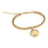 Gold-toned chain link bracelet with a circular charm featuring a raised tiger head motif and pavé-set clear crystals.
