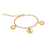 Gold-toned curb chain bracelet with three charms: two patterned rings and one circular charm with a stylised 'J' logo, featur
