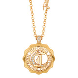 Gold-toned rolo chain necklace with a round medallion pendant featuring a stylised 'J' initial and clear crystals.