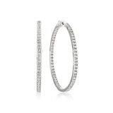 Pair of silver-toned inside-out hoop earrings with clear sparkling stones set along both inner and outer surfaces.