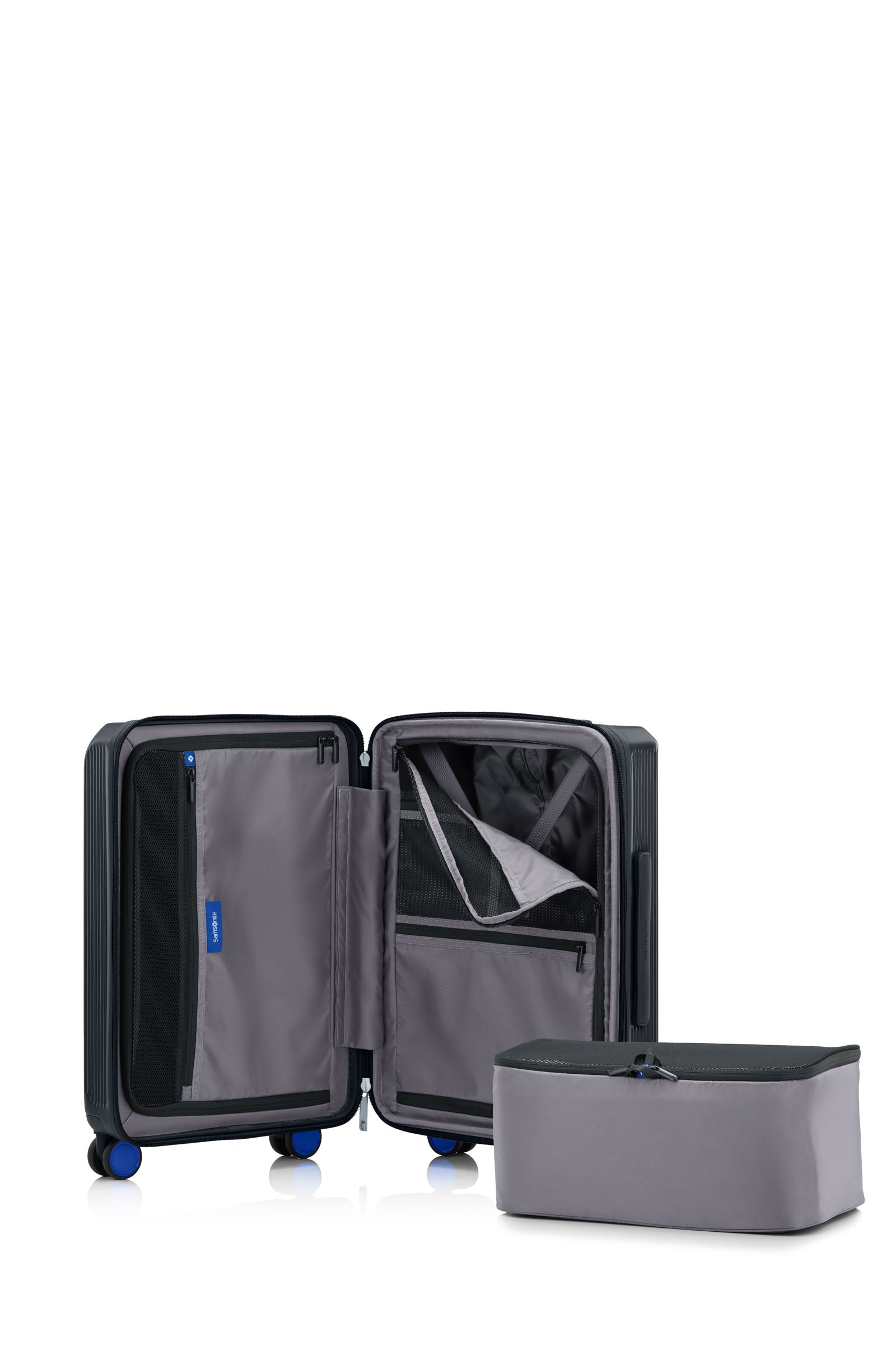 interior view of the Samsonite Voypod Spinner cabin in Black, revealing the grey recycled fabric lining, height-adjustable packing straps, and dual zippered divider pads. Available for Online Purchase