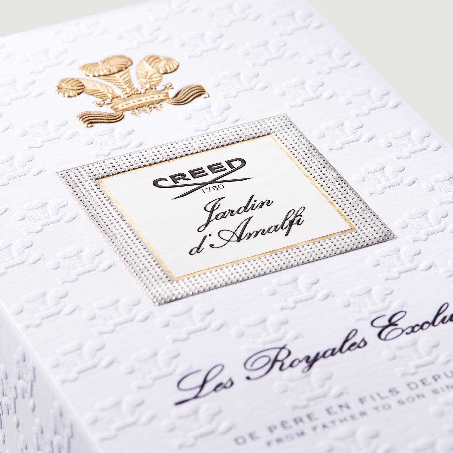 White embossed box with a gold-toned crest. A square label with a silver-toned textured border reads 'CREED Jardin d'Amalfi'.