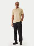 Sand short-sleeve polo shirt with a white-trimmed collar, black placket detail, and matching embroidered logo on the chest.