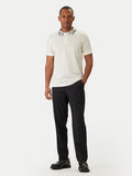 Champagne short-sleeved polo shirt with a white collar featuring a black and white geometric pattern and a three-button plack