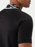 Black short-sleeved polo shirt with a white and black 'KL' monogram patterned ribbed collar and ribbed cuffs.