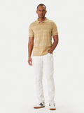 Camel short-sleeve polo with horizontal textured stripes, white-trimmed collar and cuffs, and 3 gold-toned buttons.