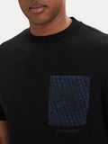 Black crewneck t-shirt with a dark blue chest pocket featuring a repeated 'KARL LAGERFELD' text pattern. Subtle logo print be