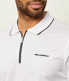 White long-sleeve polo shirt with black-trimmed collar, black zipper, silver-toned 'KARL' pull, and 'KARL LAGERFELD' logo.