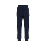 Navy jogging pants with an elastic waistband, ribbed ankle cuffs, and a single patch pocket on the back right.
