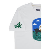Optic white short-sleeved t-shirt. Green embroidered 'LM' on left sleeve. Front graphic: horse and rider in field, blue sky,
