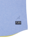 Light blue woven shirt with an embroidered "A" logo and a black "Polo Player La Martina" patch. Yellow trim visible at the cu